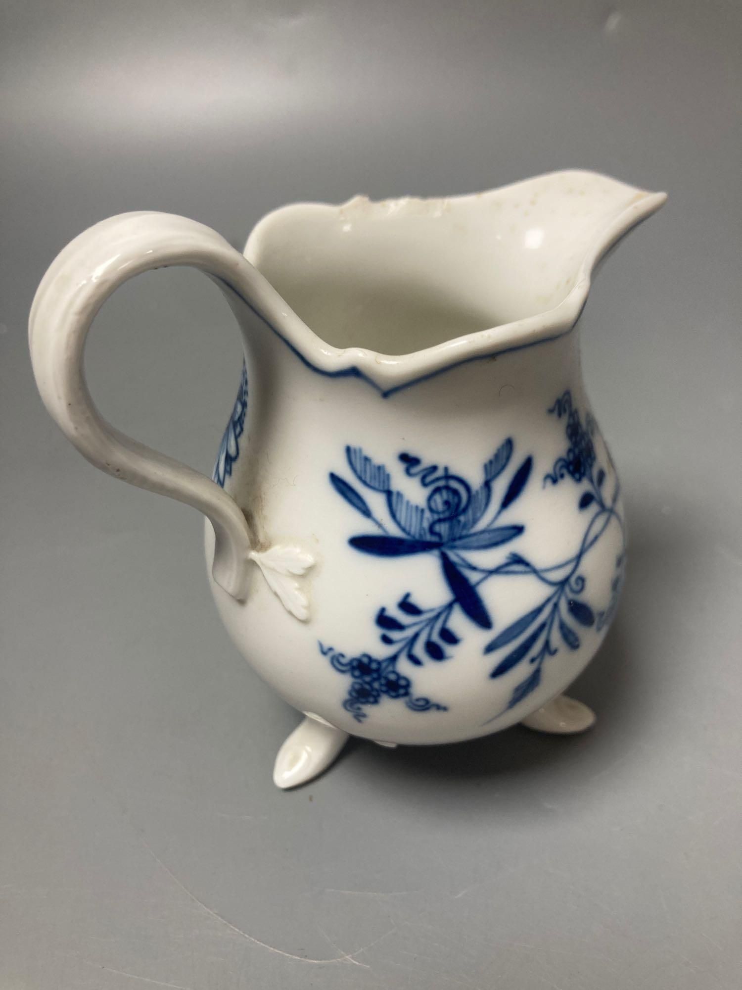 A Meissen blue and white onion pattern jug and a similar leaf shaped pickle dish (2)